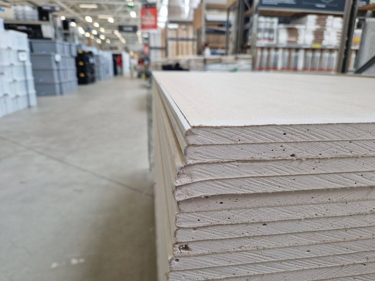 Crafting Captivating Headlines: Your awesome post title goes here Close-up of drywall sheets stacked in a large warehouse in London.